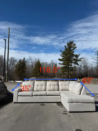 This stylish grey sectional sofa, measuring 118.5" in length, 63" in width, and 35" in height, is th...
