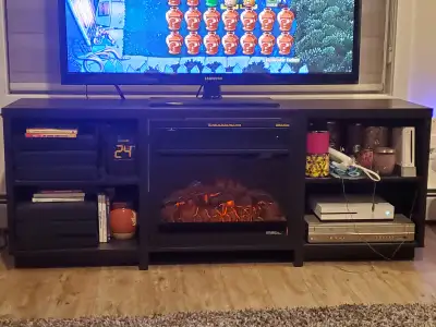 64" long x 25" height x 16" wide black/brown tv stand. 4 shelves Fireplace insert with remote emits...