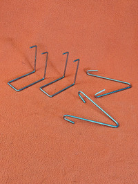 Four silver brackets for various hanging applications