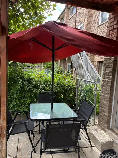 Patio set with 4 folding chairs and large umbrella Excellent condition and clean Umbrella size: 76”x...