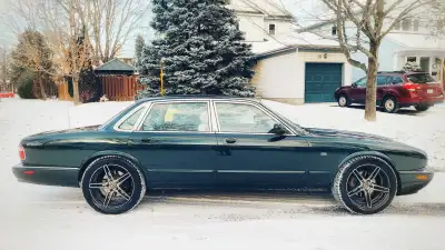 Selling a timeless 2001 Jaguar XJ8, finished in the iconic British Racing Green with a cream-colored...