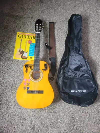 This Hua Wind classical guitar is perfect for beginners, complete with a case, tuner, capo, picks, s...