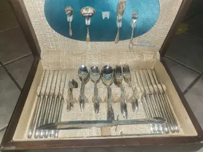 A comprehensive cutlery set featuring sterling silver pieces. Includes various serving utensils. Per...