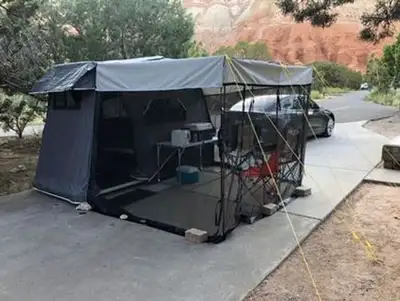 It's a light weight tent trailer with a double bed inside. It has a fold out screened porch, a spare...