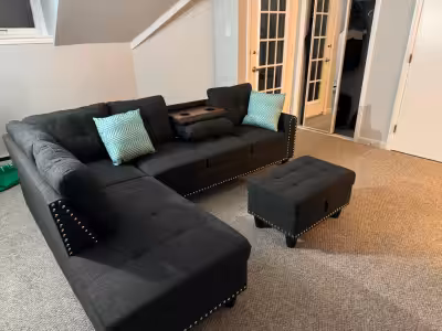 This stylish sectional sofa with ottoman is in used condition, perfect for adding comfort and style...