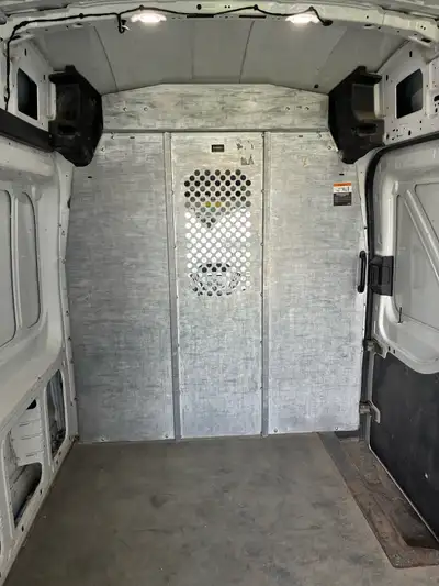 Heavy-duty galvanized steel bulkhead/divider currently installed in a Ford Transit High Roof cargo v...