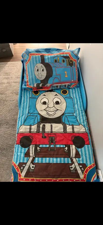 Thomas the Tank Engine toddler bed. Comes with pillow case, fitted sheet, quilt, and mattress. Measu...