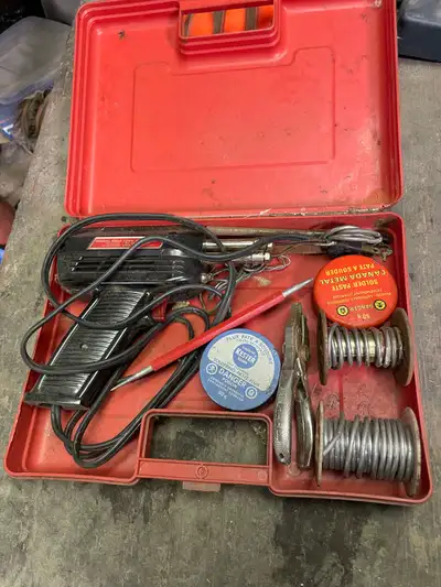 This is a used vintage soldering gun kit, complete with soldering gun, solder, paste and other acces...