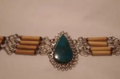 This beautiful little bracelet is 1/2 inch wide X 8 inches long. The green pendant stone...isn't a s...
