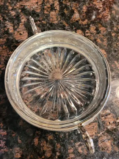 Antique round glass butter dish in silver plated stand. Not sure of the age, it's at least early 20t...