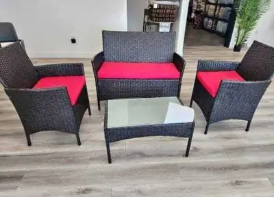 This new four-piece outdoor patio set includes a loveseat, two chairs, and a glass-topped table, per...