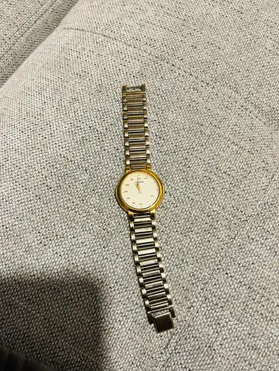This Seiko watch features a gold and silver band, giving it a classic and timeless look. Additional...