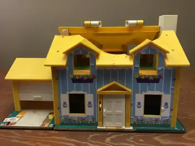 Fisher Price Little People house. Part of roof is missing. Assorted Little People and furnishings in...