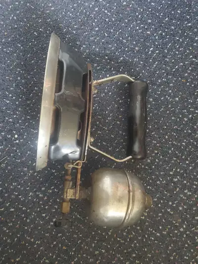 Add a touch of historical charm to your space with this vintage gasoline-powered sad iron, currently...