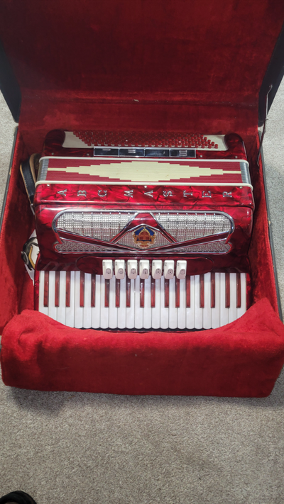 Vintage Italian-made piano accordion by Master. Classic red pearloid finish. This full-size 120-bass...