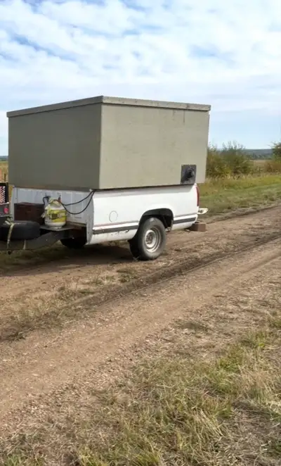 Portable truck trailer converted to a hunting blind with lights, propane heater microwave oven and p...