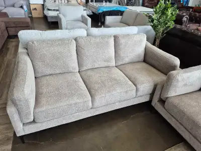 This 3pc beige sofa set includes a three-seater sofa, a loveseat, and an armchair, all featuring a n...
