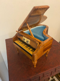 Vintage wooden music box in shape of grand piano.
