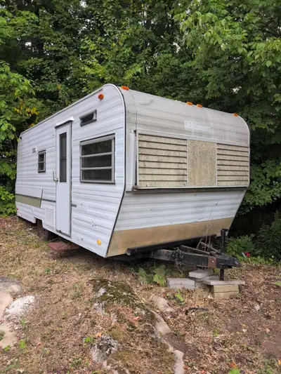 This vintage Corsair travel trailer, while showing its age, offers a fantastic project opportunity f...