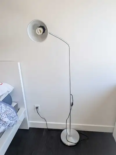 Brighten up your living space with this sleek, silver-finished IKEA floor lamp in good condition. Th...