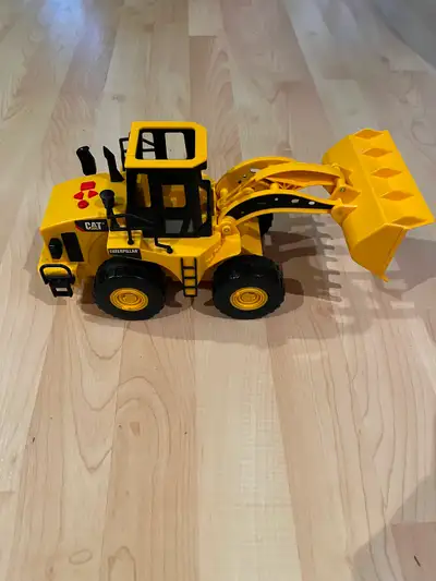 This Caterpillar tractor loader with bucket that lifts at touch of lever -goes forward, backwards an...