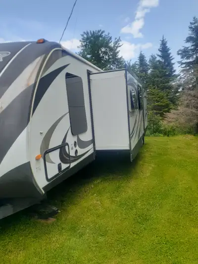 Two slides, 2 bedrooms, bunkbeds in rear bedroom, queen in front bedroom with TV, fold down couch, f...