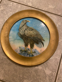Antique brass framed ceramic wall hanging plate. 8.5”.