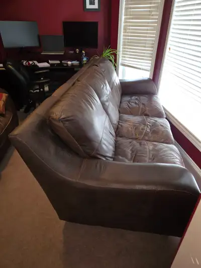This couch has some wear, but no tears in the leather. It would be great for a basement or man cave....