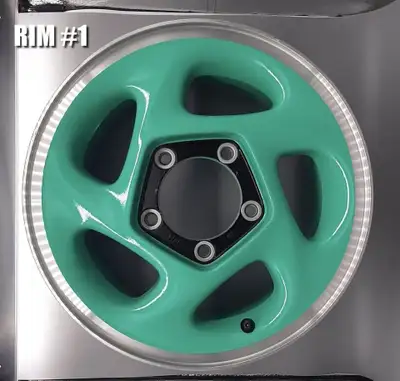 This is a set of four rims, factory-painted in teal for a Geo Tracker. These were a limited-edition...