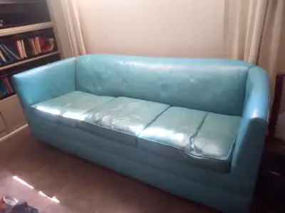 Turquoise leather. About 76"w x 34"deep. 3 seater. Casters. Cushions have some wear as shown but not...