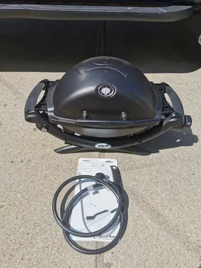 Excellent working condition Black Weber Q1200 portable BBQ with side shelves. Has been cleaned very...