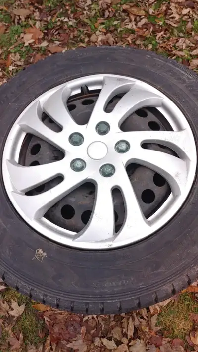 Dunlop winter tires on 5x105 rims with hubcaps. Fit Chevy Trax etc. Pick up in Atwood
