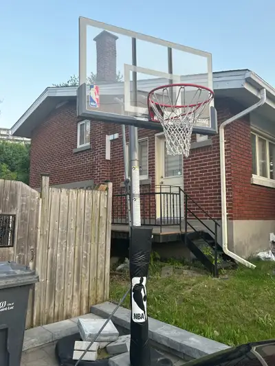This is a used Spalding NBA basketball net with adjustable height, perfect for some outdoor fun. The...