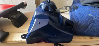 This is a used Yamaha YZ250 fuel tank, perfect for your off-road adventures. The tank is in good con...