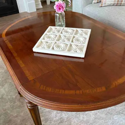 Elegant solid wood cocktail table. Extends to an oval layout when both ends extend. Beautiful fluted...