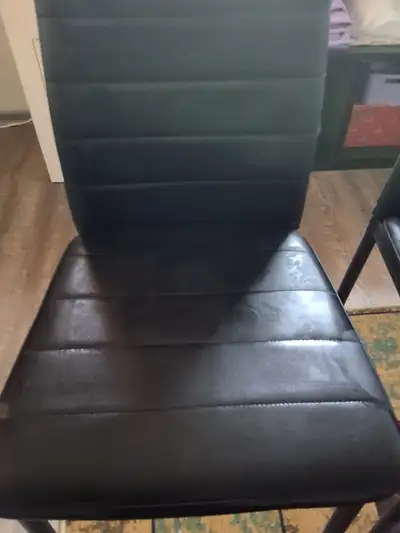Two black kitchen chairs., View more