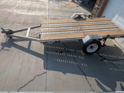 4'x8' folding aluminum Marlon trailer. 5/8" plywood deck with three 8' lengths of e track to secure...