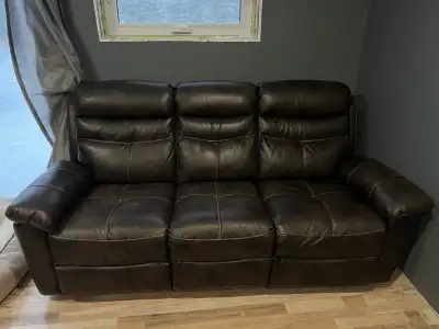 Leather manual reclining sofa and love seat, purchased new from leons a couple years ago for just ov...