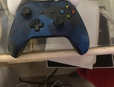 Selling a used blue camo Xbox One controller, fully functional and ready for gaming. It's been well...