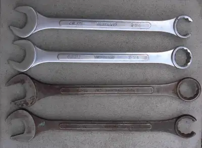 Four 2 1/4 combination wrenches. Two are regular and two are line wrenches. Big wrenches for those b...
