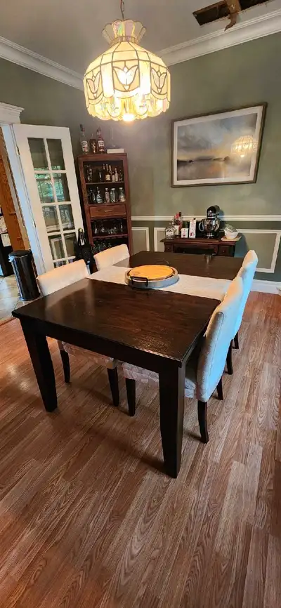 Upgrade your dining space with this elegant dining table and chair set. The set is used, but in good...