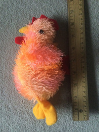 Plush chicken with suction cup hanger.