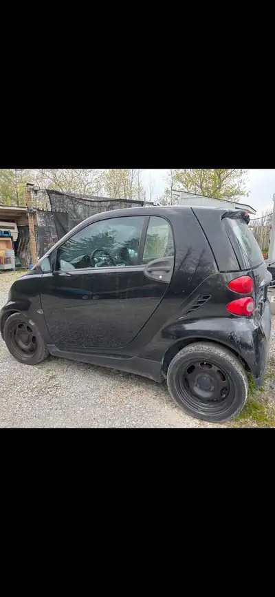 This is a black Smart Fortwo with a quirky design and compact size, perfect for city driving. Please...