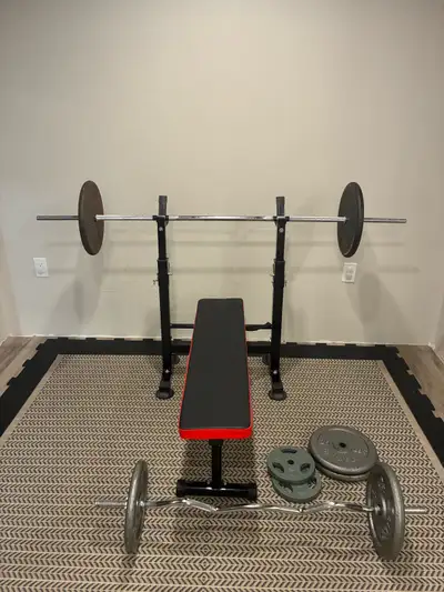 Complete with bench, barbell, curl bar, and 210lbs of standard weight plates 50lbs x2 25lbs x4 10lbs...