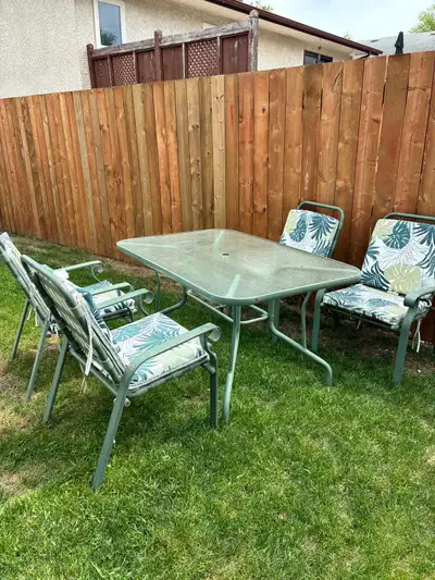 Patio set with four chairs and cushions. , View more