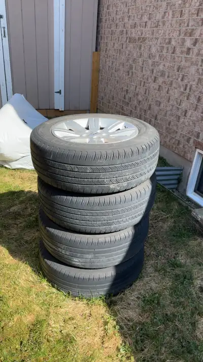 Set of 4 used tires with rims for sale. Tires are in fair condition with visible tread remaining, go...
