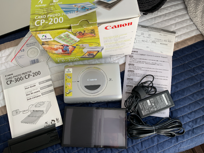 Canon CP-200 Photo Printer + Canon Selphy Ink Postcard Paper Set, View more