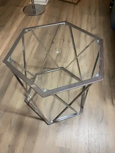 glass top coffee table, with steel frame. Hexagon measure is Height is 2feet, side is 14 inches. Wid...