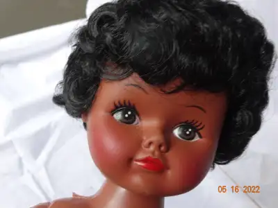 16 inch black/native doll wearing mocassins with beading. She could have been a Souvenir dressed dol...