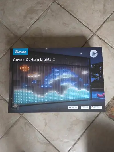 Brand new in box 3 panel curtain light 2 by govee. This is perfect size for garage door or other lar...